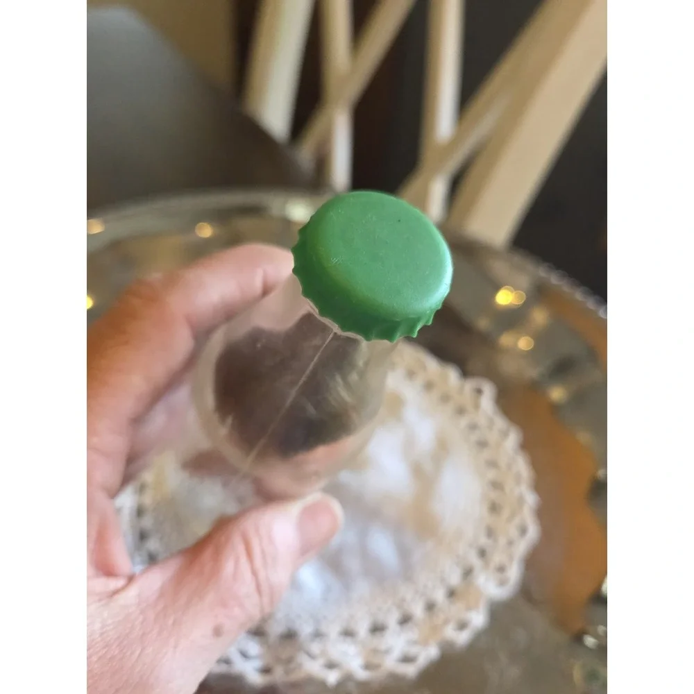 vintage 1960s Cola Kids doll is encased in a clear plastic bottle